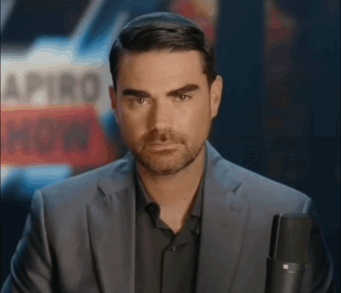Man In Suit Holding Microphone GIF