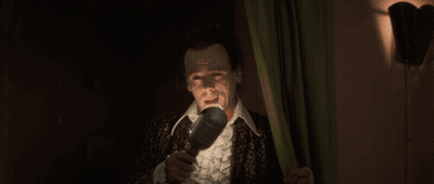 Man In Suit Holding Microphone GIF