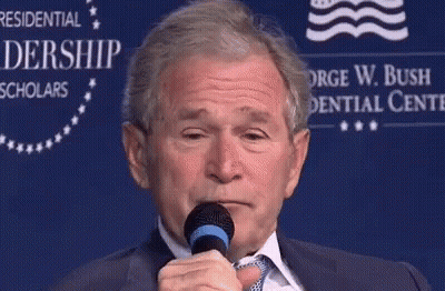 Man In Suit Holding Microphone GIF