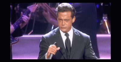 Man In Suit Holding Microphone GIF