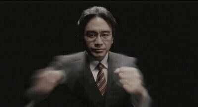 Man In Suit Holding Microphone In Dark Room GIF