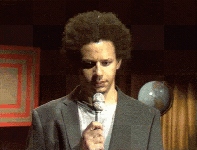 Man In Suit Holding Microphone In Front Of Globe GIF