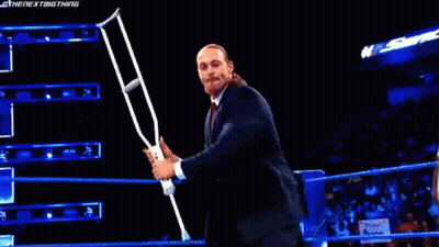 Man In Suit Holding Microphone In Wrestling Ring GIF