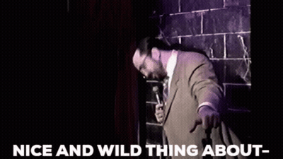 Man In Suit Holding Microphone GIF