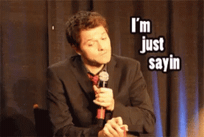Man In Suit Holding Microphone Saying I'm Just Sayin GIF