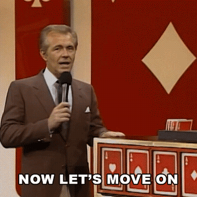 Man In Suit Holding Microphone Saying Now Let's Move On GIF