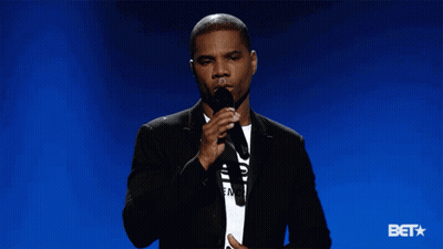 Man In Suit Holding Microphone Says Bet GIF