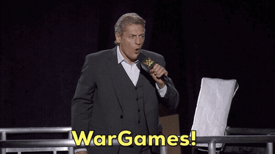 Man In Suit Holding Microphone Says Wargames GIF