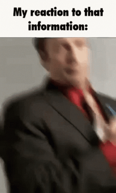 Man In Suit Holding Microphone Talking GIF