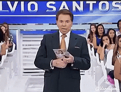 Man In Suit Holding Microphone To Crowd GIF
