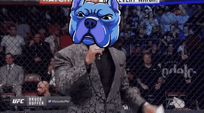 Man in Suit Holding Microphone with UFC Bruce Buffer on Screen
