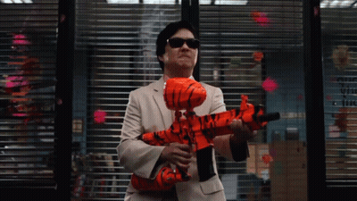 Man In Suit Holding Orange Toy Gun By Window With Sticky Notes GIF