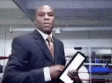 Man In Suit Holding Paper Boxing Ring GIF