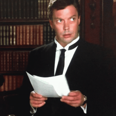 Man In Suit Holding Paper GIF