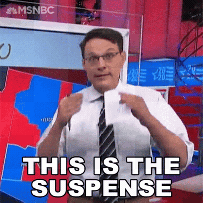 Man In Suit Holding Paper Saying This Is The Suspense GIF