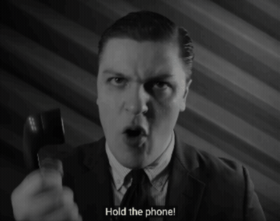 Man In Suit Holding Phone GIF