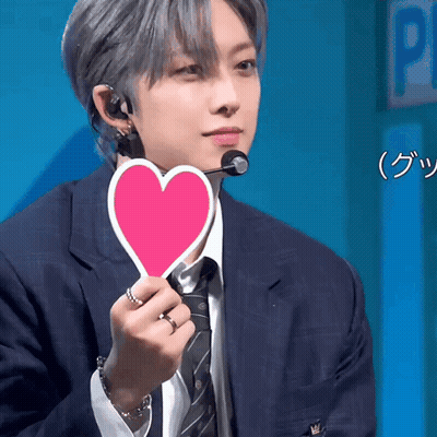 Man In Suit Holding Pink Heart GIF
