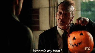 Man In Suit Holding Pumpkin Asking Where's His Treat GIF