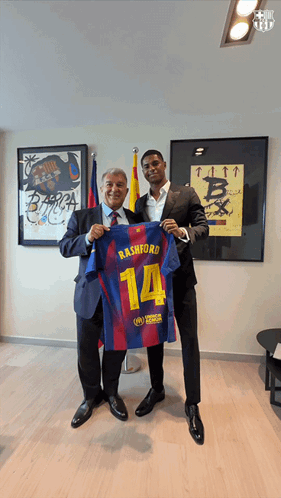 Man In Suit Holding Rashford Jersey GIF