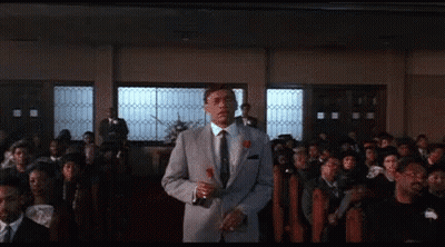 Man In Suit Holding Rose In Front Of Crowd GIF