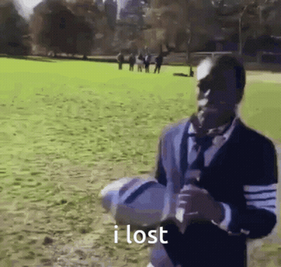 Man In Suit Holding Soccer Ball In Field GIF