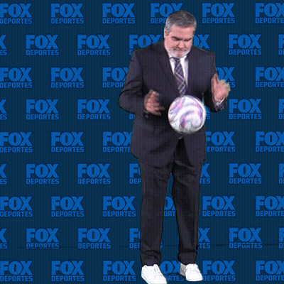 Man In Suit Holding Soccer Ball In Front Of Fox Deportes Wall GIF