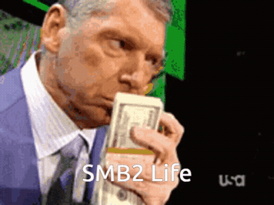 Man In Suit Holding Stack Of Money Saying SMB2 Life GIF