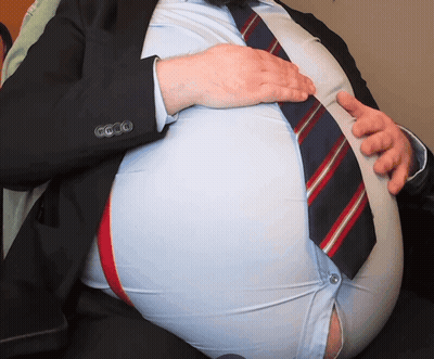 Man In Suit Holding Stomach GIF
