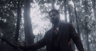 Man In Suit Holding Sword In Forest GIF