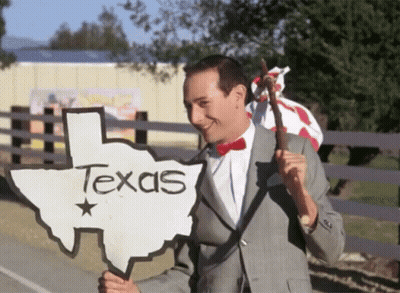 Man In Suit Holding Texas Sign GIF
