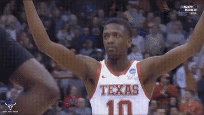Man In Suit Holding Texas Sign GIF