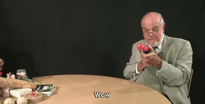 Man In Suit Holding Toy Gun Saying Wow GIF