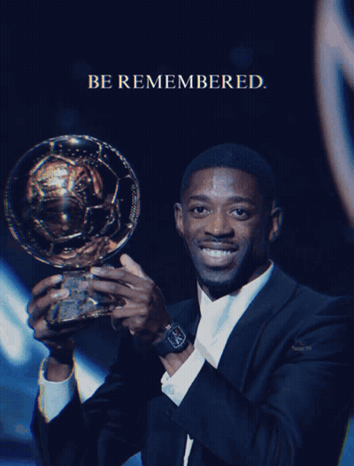 Man in Suit Holding Trophy Be Remembered