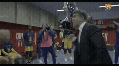 Man In Suit Holding Trophy In Locker Room GIF