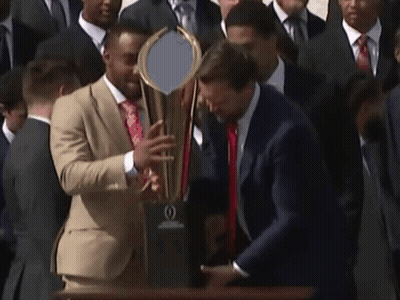 Man In Suit Holding Trophy GIF