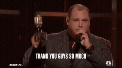 Man In Suit Holding Trophy Singing Into Microphone Saying Thank You Guys So Much GIF