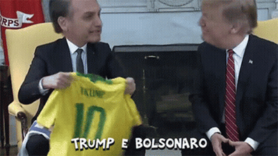 Man In Suit Holding Trump 10 Shirt GIF