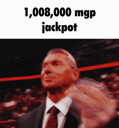 Man In Suit Holding Up Fist Saying Jackpot GIF