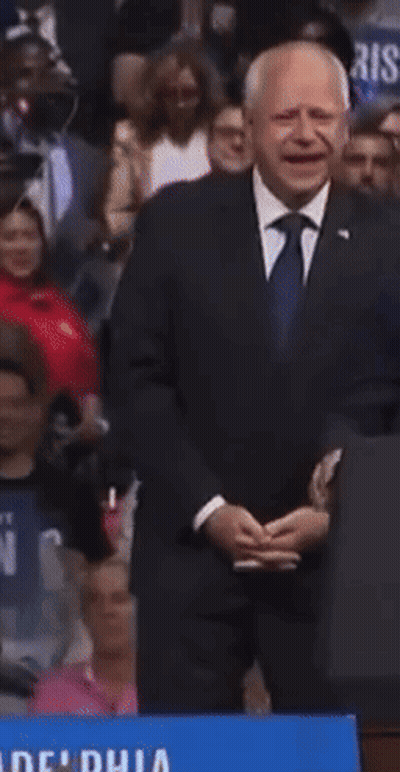 Man In Suit Holding We Win Sign GIF