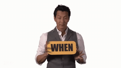 Man In Suit Holding When Sign GIF