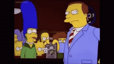 Man In Suit Holding Whiskey In Front Of Simpsons Characters GIF
