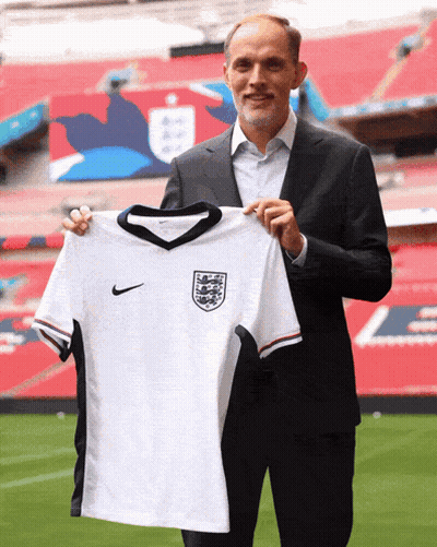 Man In Suit Holding White Nike Jersey GIF