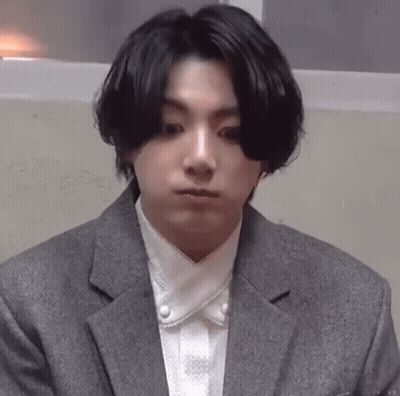 Man In Suit Holding White Towel Around Waist GIF