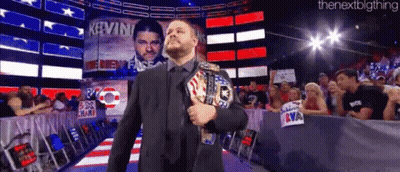 Man In Suit Holding World Heavyweight Championship Belt GIF