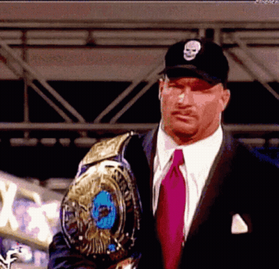 Man In Suit Holding Wrestling Championship Belt GIF