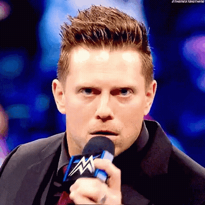 Man In Suit Holding WWE Microphone GIF