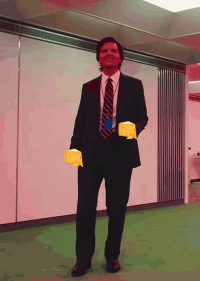 Man In Suit Holding Yellow Glove GIF