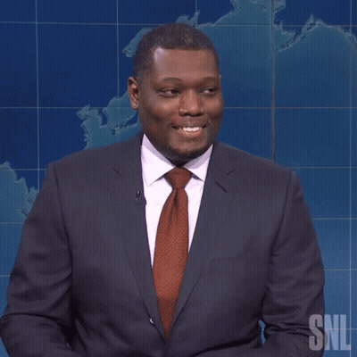 Man In Suit Holding Yellow Pencil With SNL Logo GIF
