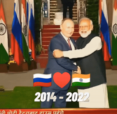 Man In Suit Hugging Another Man In Front Of Flags 2014-2022 GIF
