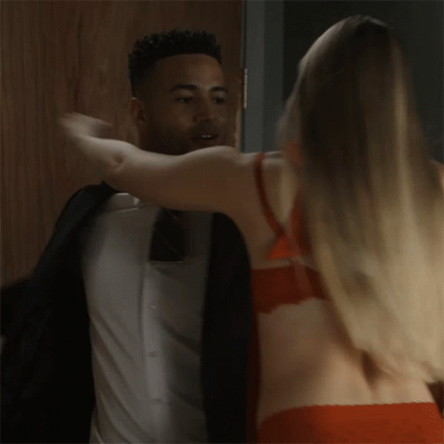 Man In Suit Hugging Woman In Bra GIF